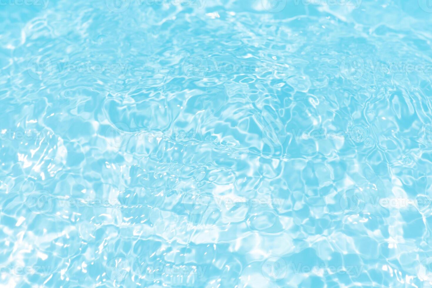 Bluewater waves on the surface ripples blurred. Defocus blurred transparent blue colored clear calm water surface texture with splash and bubbles. Water waves with shining pattern texture background. photo