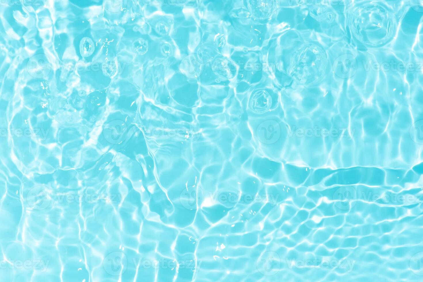 Bluewater waves on the surface ripples blurred. Defocus blurred transparent blue colored clear calm water surface texture with splash and bubbles. Water waves with shining pattern texture background. photo