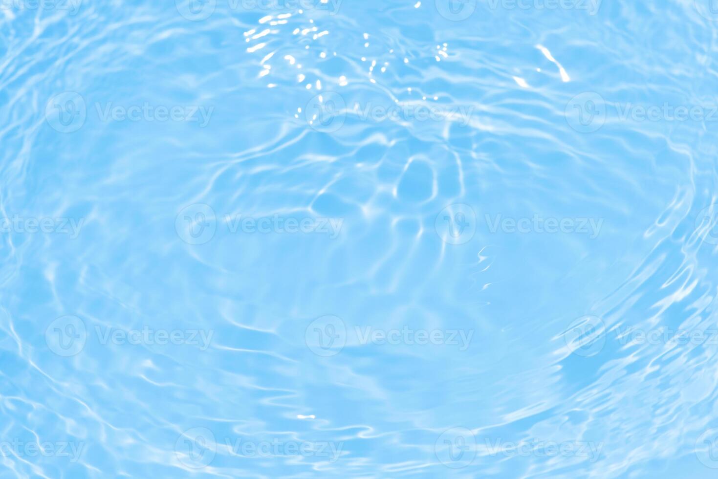 Bluewater waves on the surface ripples blurred. Defocus blurred transparent blue colored clear calm water surface texture with splash and bubbles. Water waves with shining pattern texture background. photo