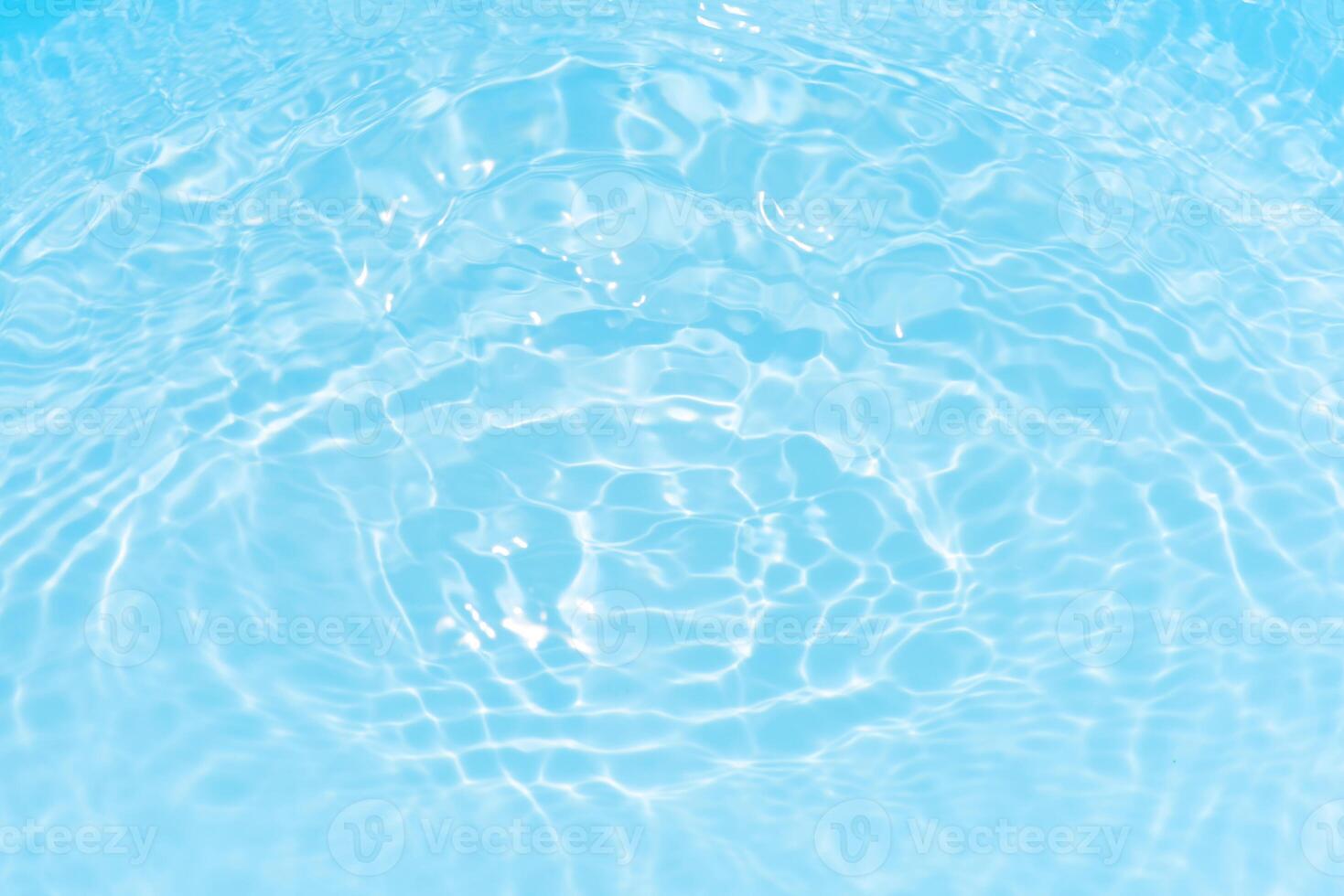 Bluewater waves on the surface ripples blurred. Defocus blurred transparent blue colored clear calm water surface texture with splash and bubbles. Water waves with shining pattern texture background. photo