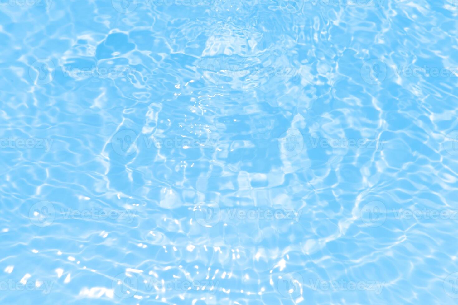 Bluewater waves on the surface ripples blurred. Defocus blurred transparent blue colored clear calm water surface texture with splash and bubbles. Water waves with shining pattern texture background. photo