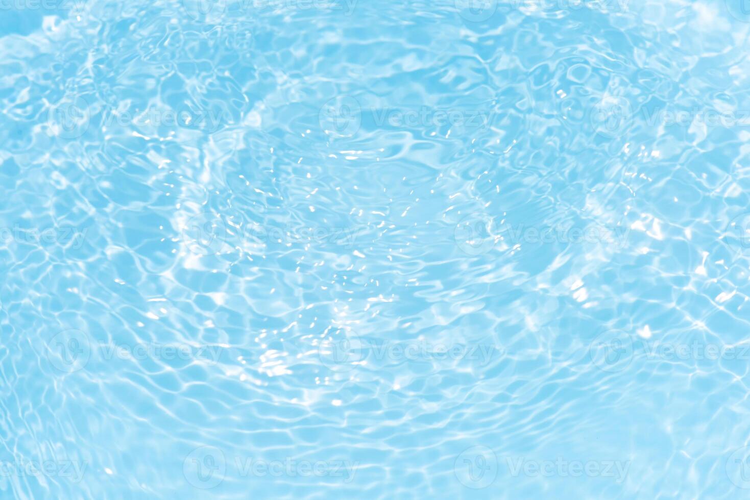 Bluewater waves on the surface ripples blurred. Defocus blurred transparent blue colored clear calm water surface texture with splash and bubbles. Water waves with shining pattern texture background. photo