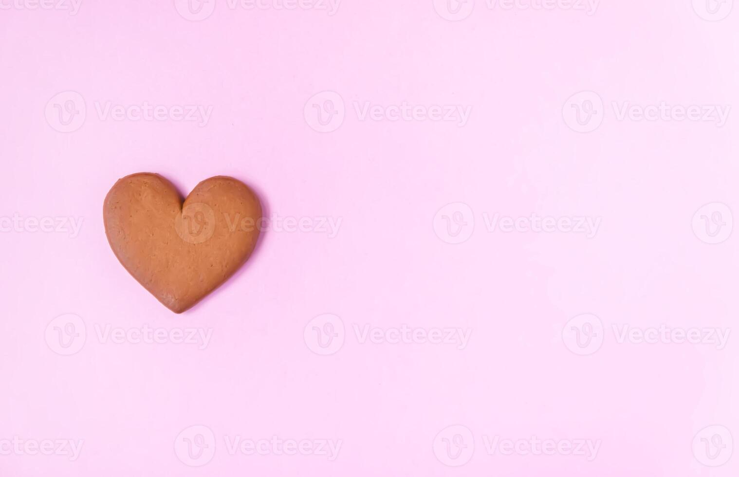 Gingerbread heart on colorful background. Valentine's day symbol. photo