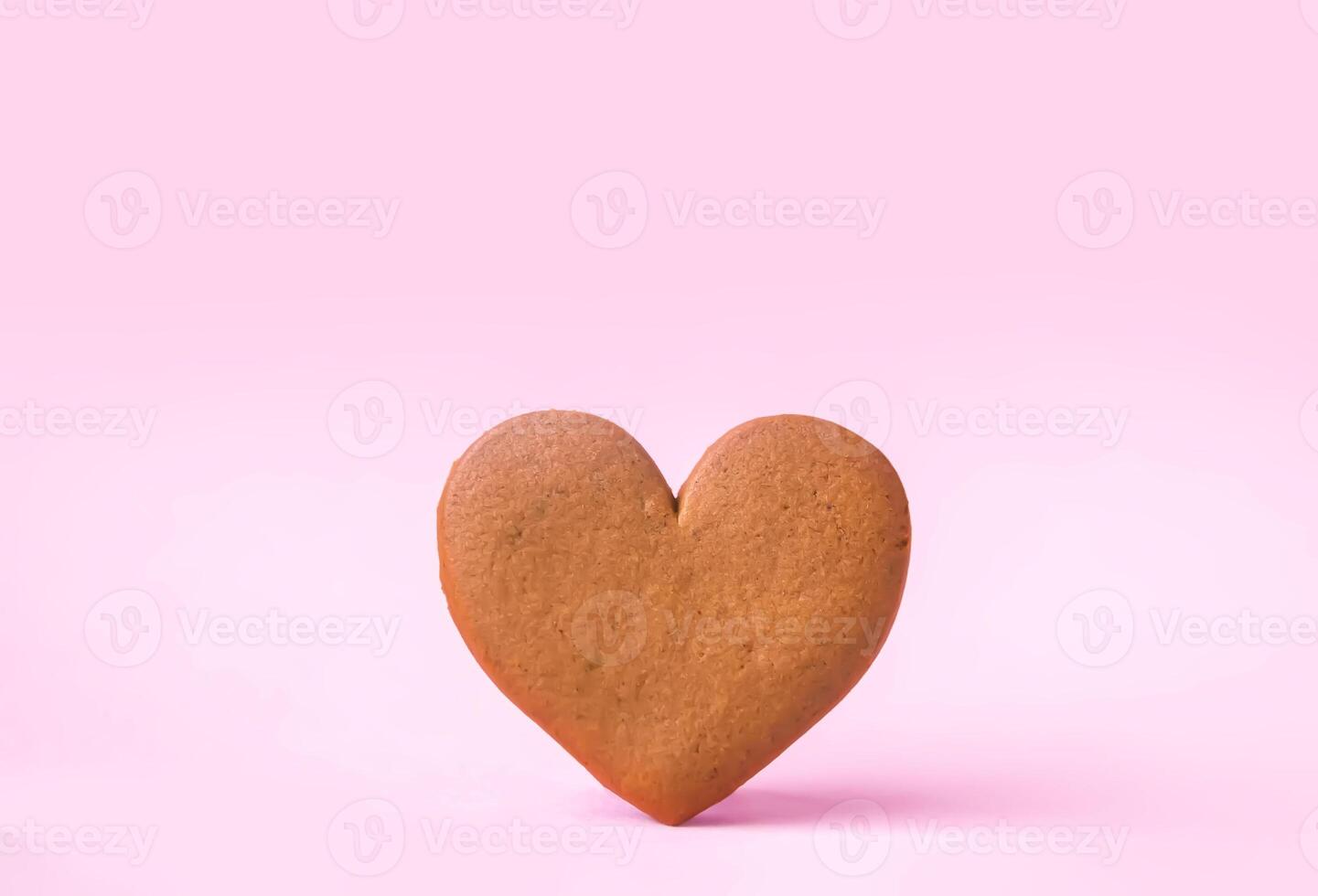 Gingerbread heart on colorful background. Valentine's day symbol. photo