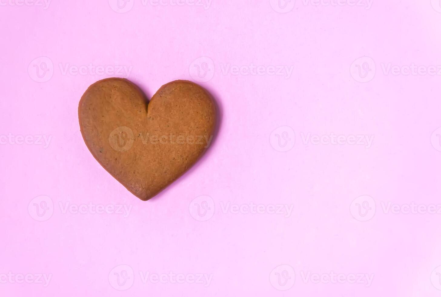 Gingerbread heart on colorful background. Valentine's day symbol. photo