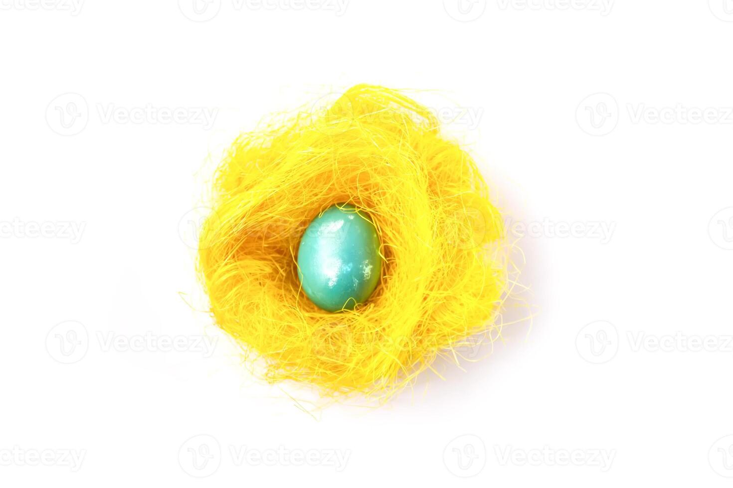 Easter egg in the artifficial nest. photo