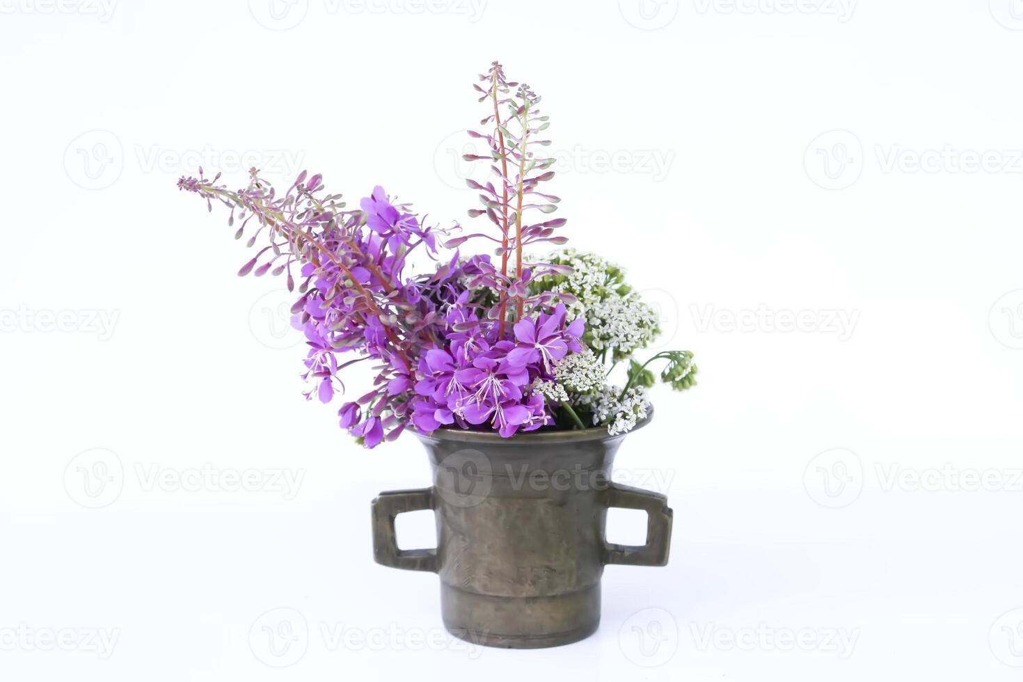Firewwed and yarrow medical plants in the copper mortar. photo