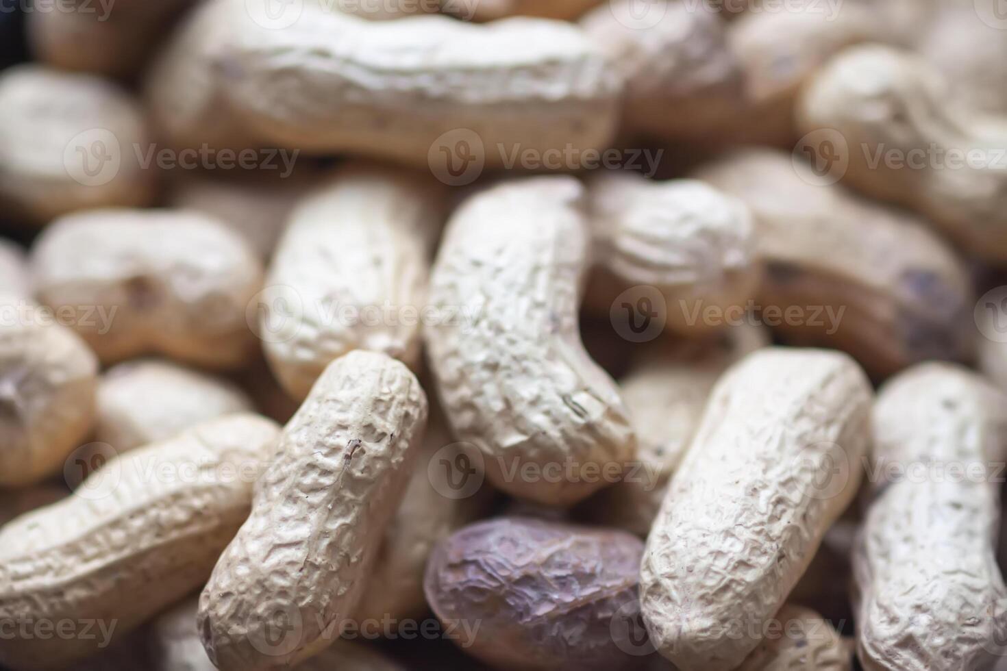 Unpeeled nuts close up. Peanuts. photo