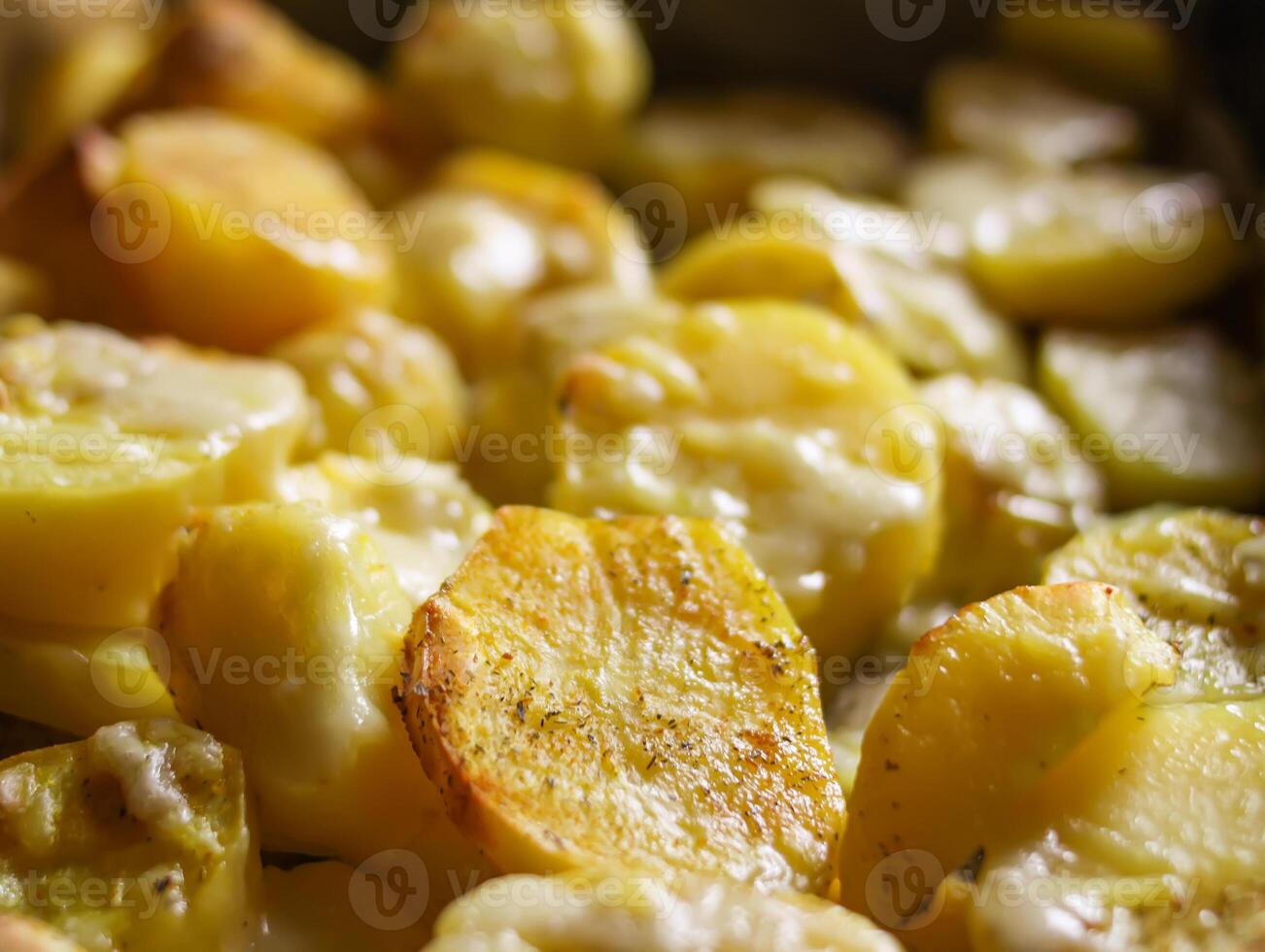 Baked spicy potatoes on tray. photo