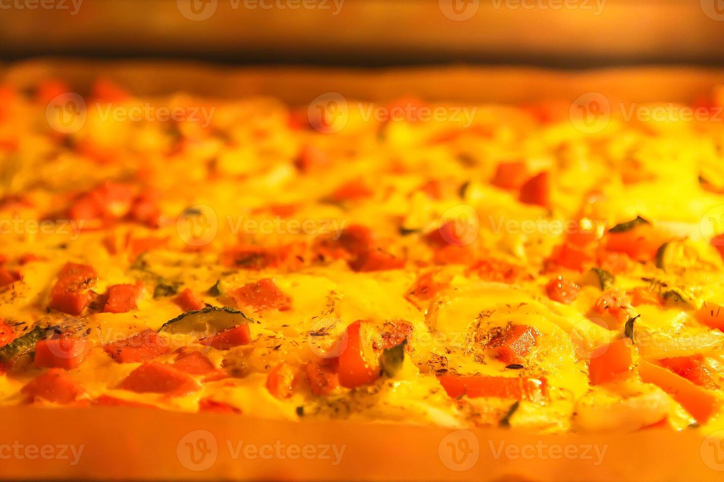 Pizza with tomatoes and meat baking in the oven photo
