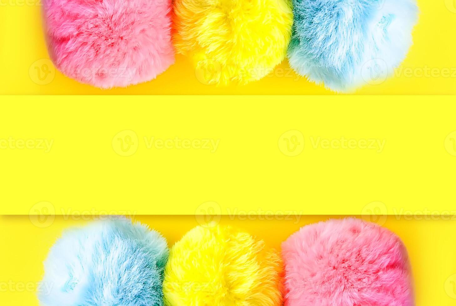 Colorful fluffy pompons on bright background. Fashion decoration festive template. photo