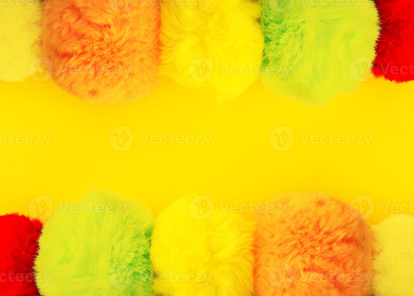 Colorful fluffy pompons on bright background. Fashion decoration festive template. photo