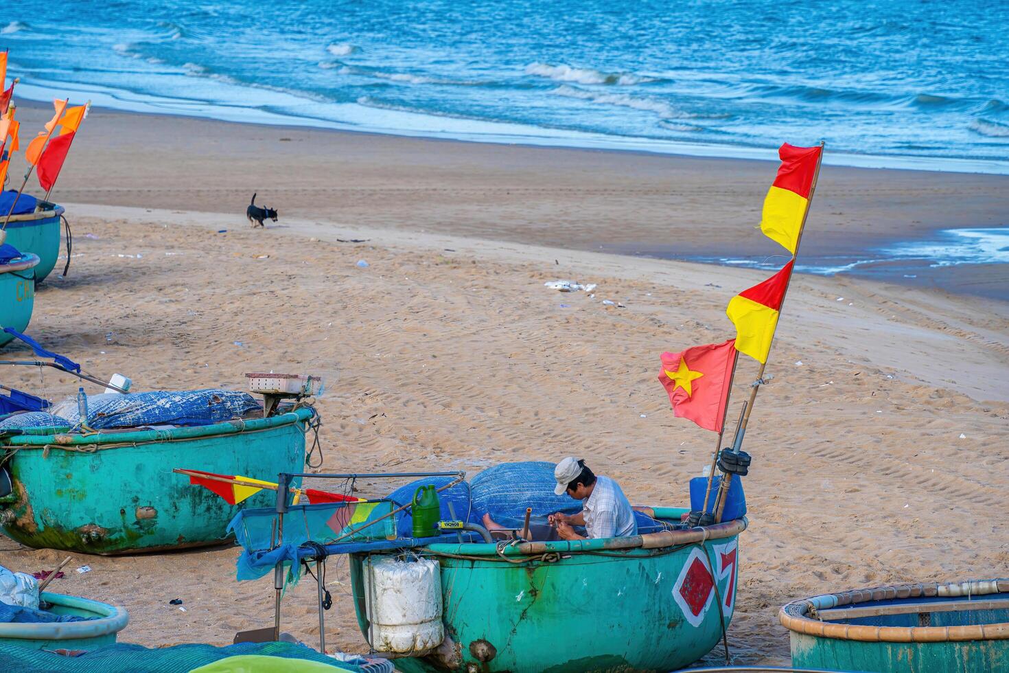 Vung Tau, VIETNAM - AUG 21 2022 Fisherman casting his net at the sunrise or sunset. Traditional fishermen prepare the fishing net. Fishermen on beach at the Fishing. photo