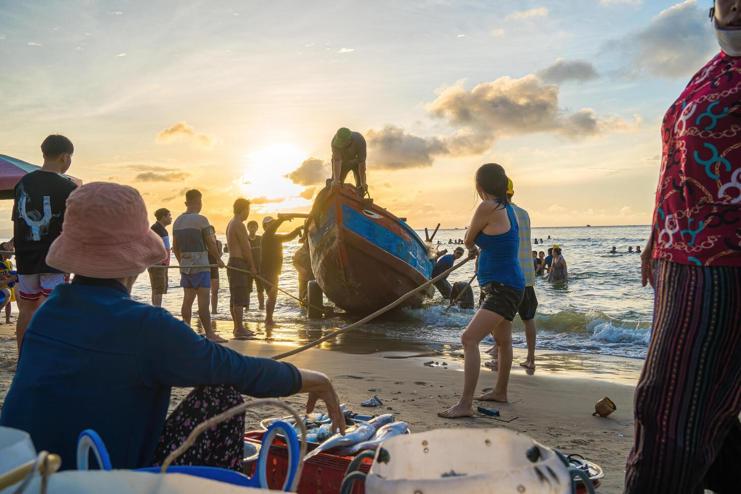 Vung Tau, VIETNAM - AUG 20 2022 Fisherman casting his net at the sunrise or sunset. Traditional fishermen prepare the fishing net. Fishermen on beach at the Fishing. photo