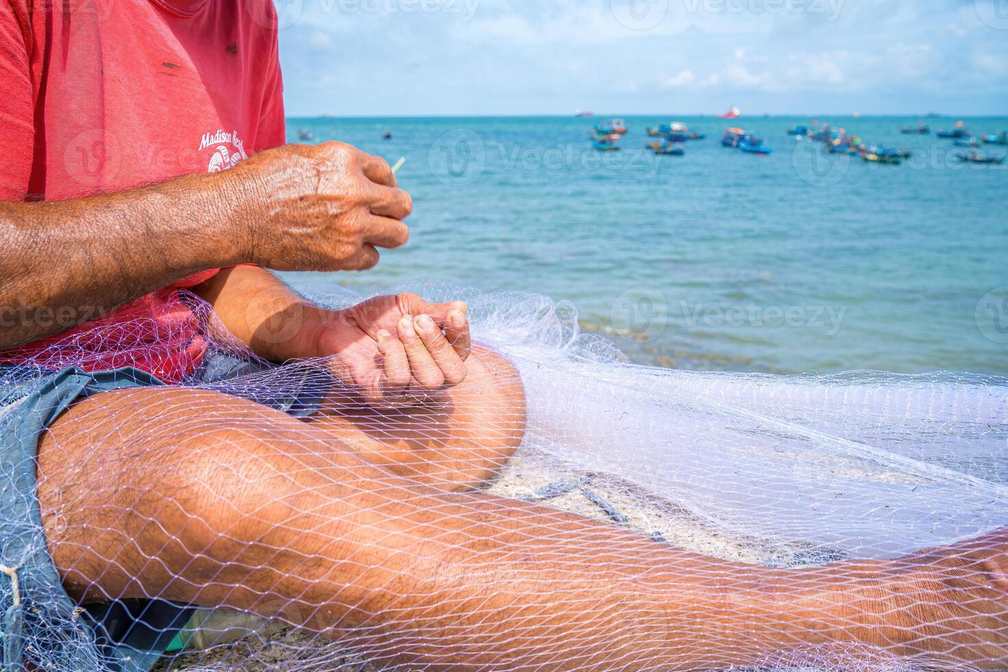 Fisherman casting his net at the sunrise or sunset. Traditional fishermen prepare the fishing net. Fishermen on beach at the Fishing. photo