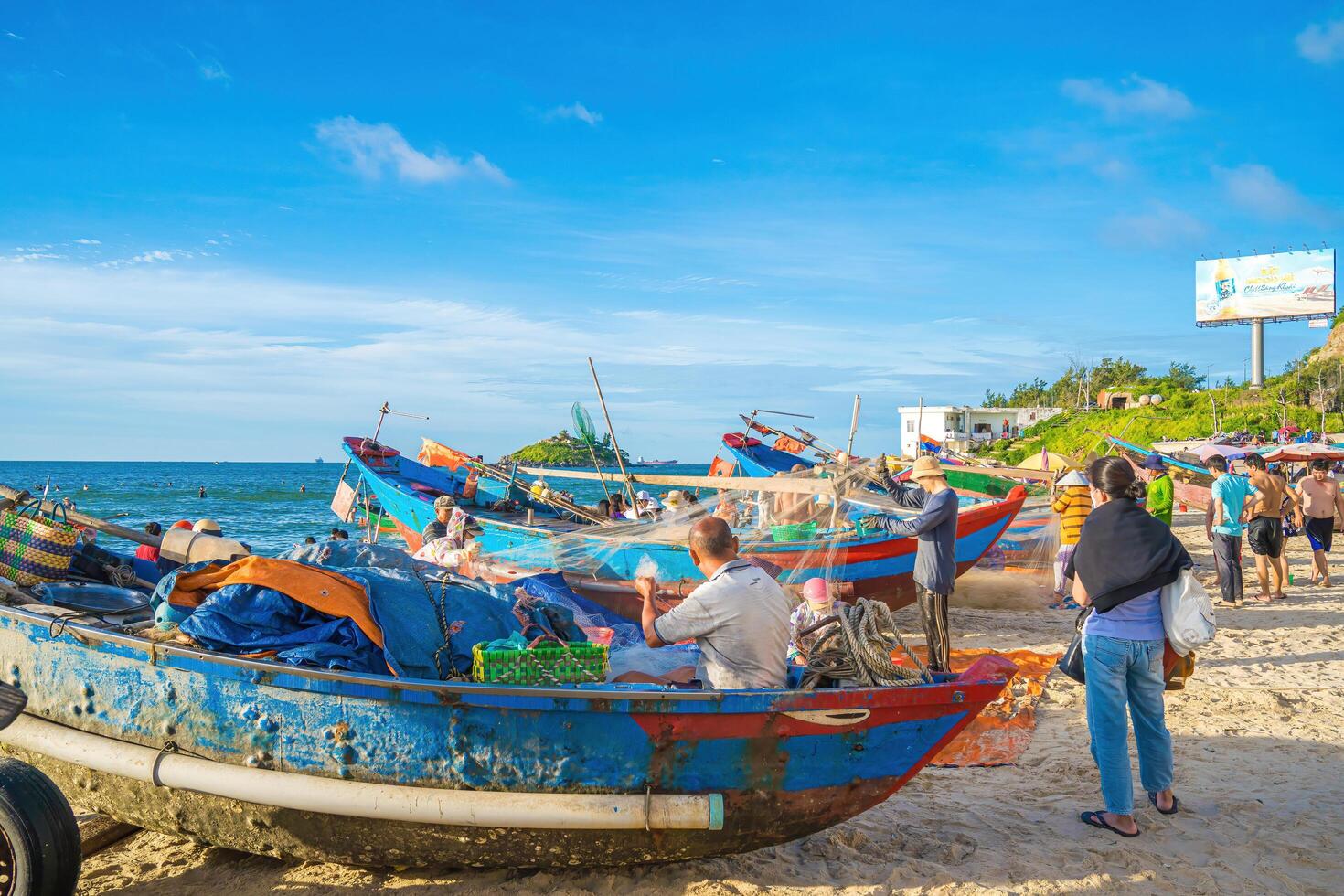 Vung Tau, VIETNAM - AUG 20 2022 Fisherman casting his net at the sunrise or sunset. Traditional fishermen prepare the fishing net. Fishermen on beach at the Fishing. photo