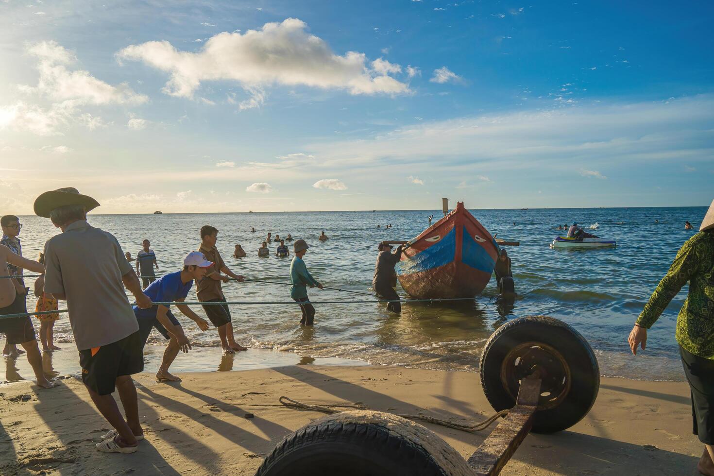 Vung Tau, VIETNAM - AUG 20 2022 Fisherman casting his net at the sunrise or sunset. Traditional fishermen prepare the fishing net. Fishermen on beach at the Fishing. photo