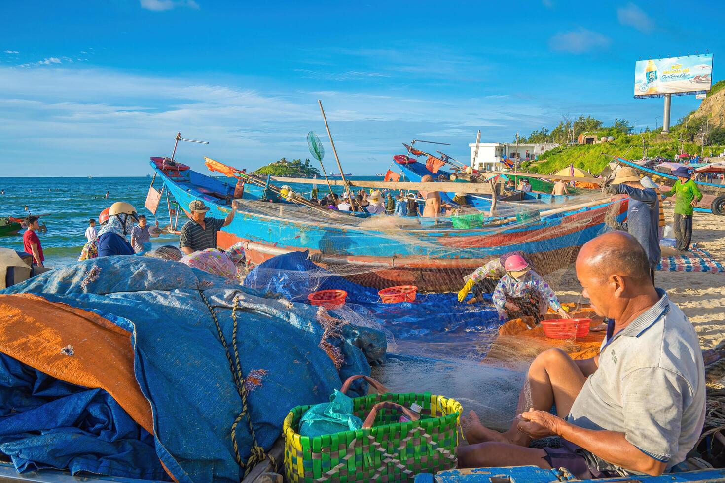 Vung Tau, VIETNAM - AUG 20 2022 Fisherman casting his net at the sunrise or sunset. Traditional fishermen prepare the fishing net. Fishermen on beach at the Fishing. photo