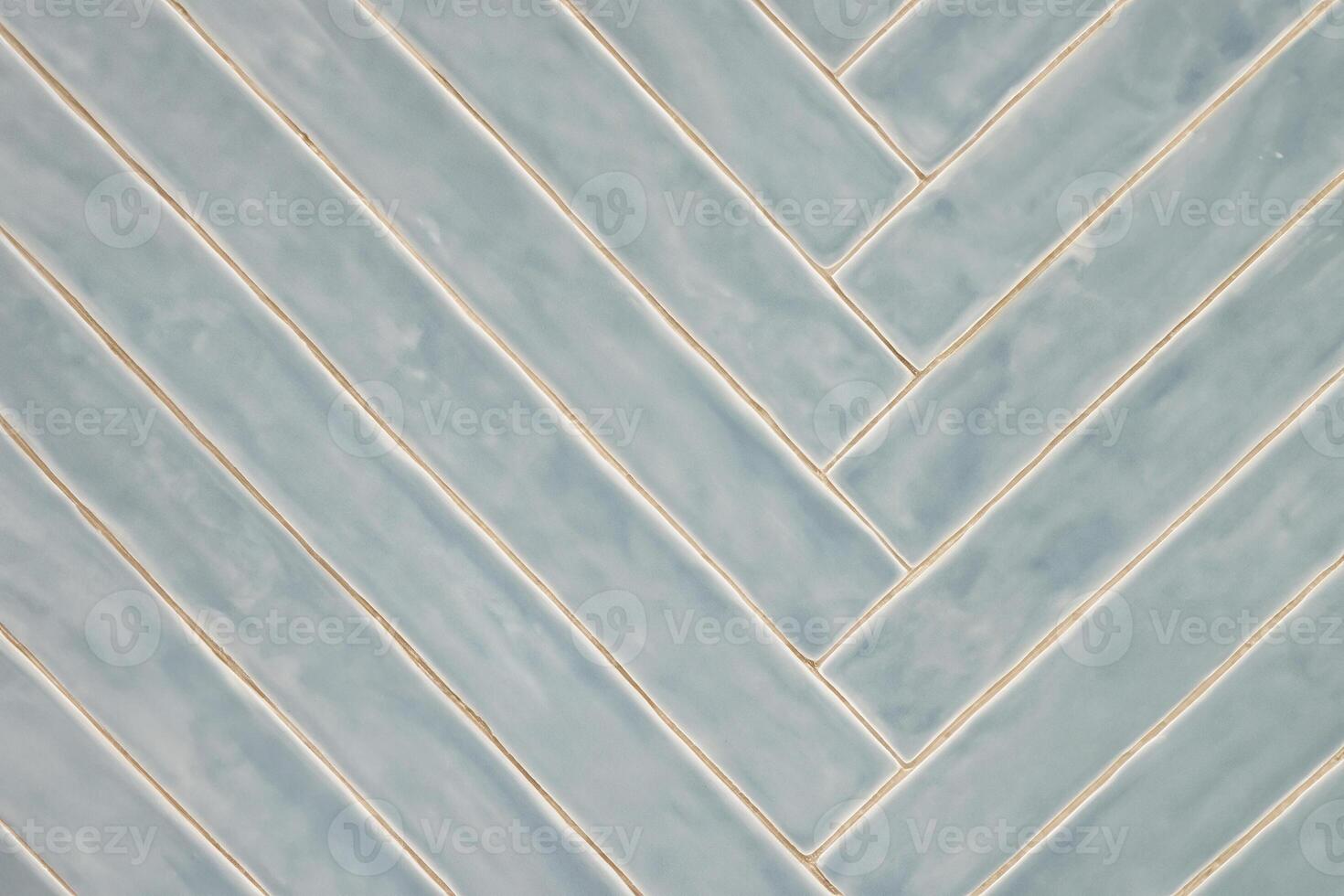 Diagonal Blue-Gray Tile Pattern with Light Glaze on Wall photo