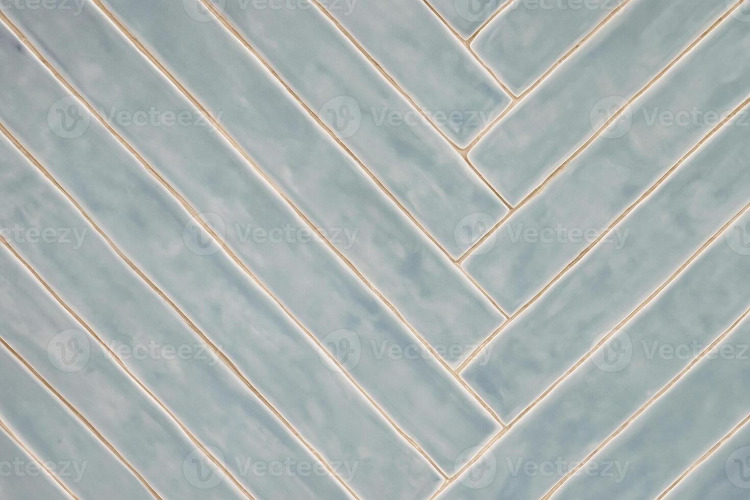 Diagonal Blue-Gray Tile Pattern with Light Glaze on Wall photo