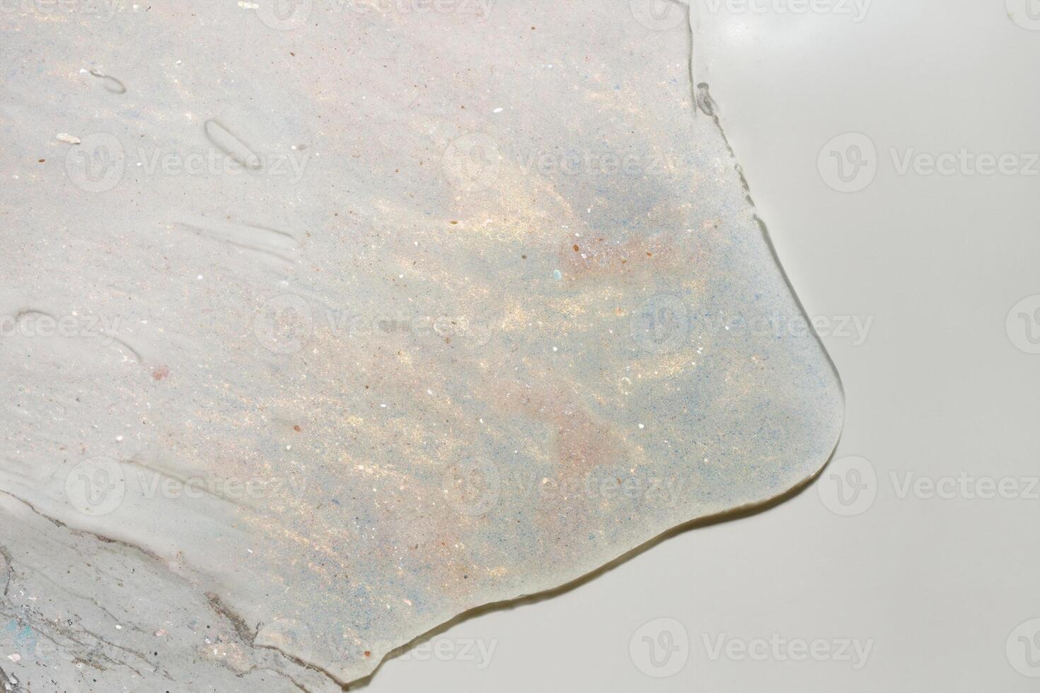 Close-Up of Pink and Gold Shimmer Gel Texture with Brush Strokes on White Background photo