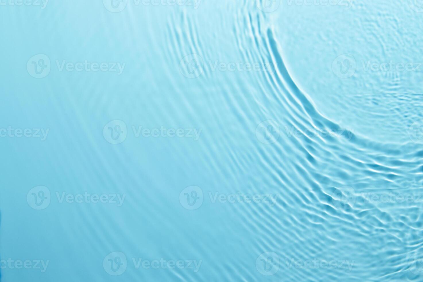 Blurred Blue Water Ripple with Bubbles and Sunlight Reflection - Calm and Clear Background photo