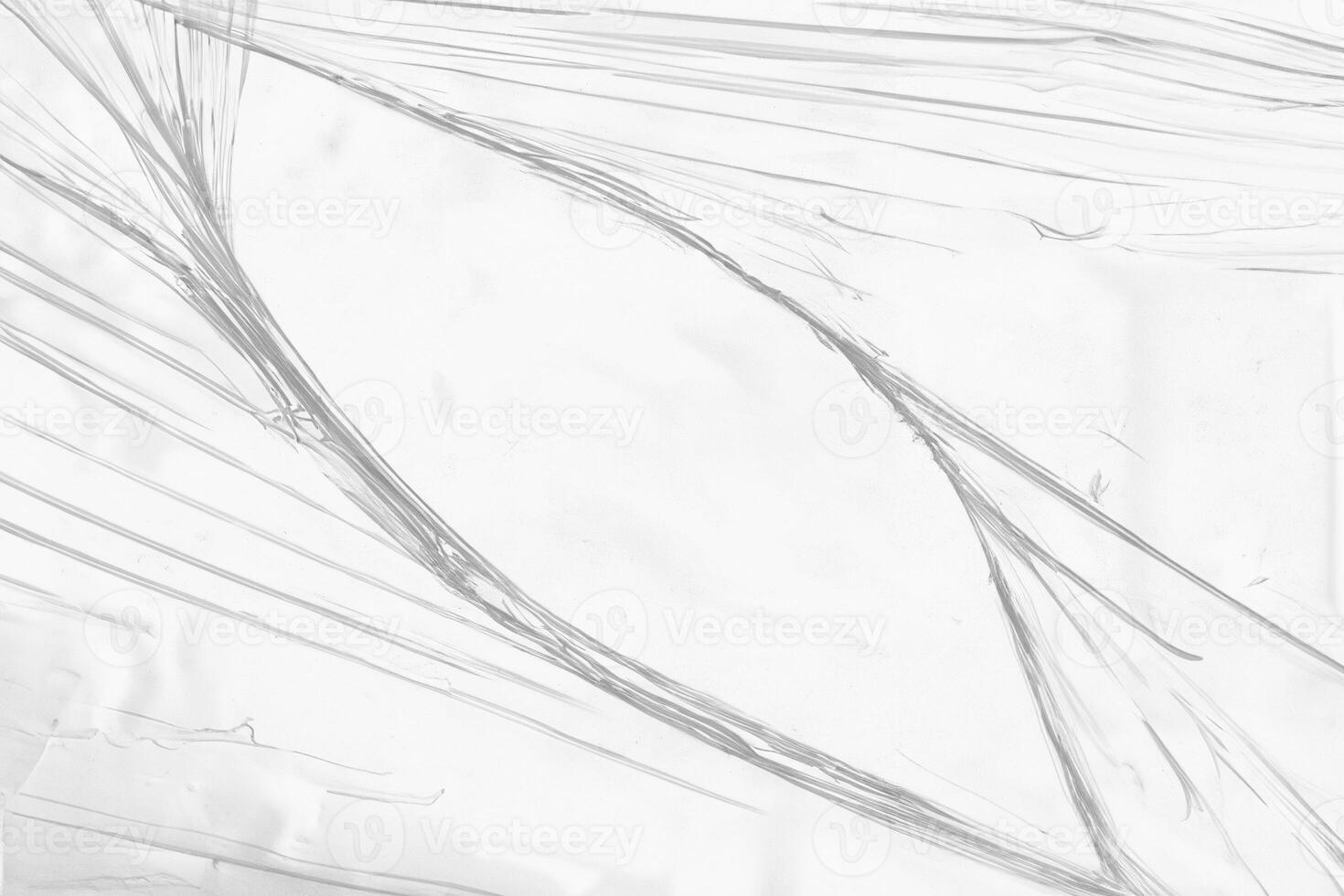Torn Hole in Clear Plastic Wrap Close-Up photo