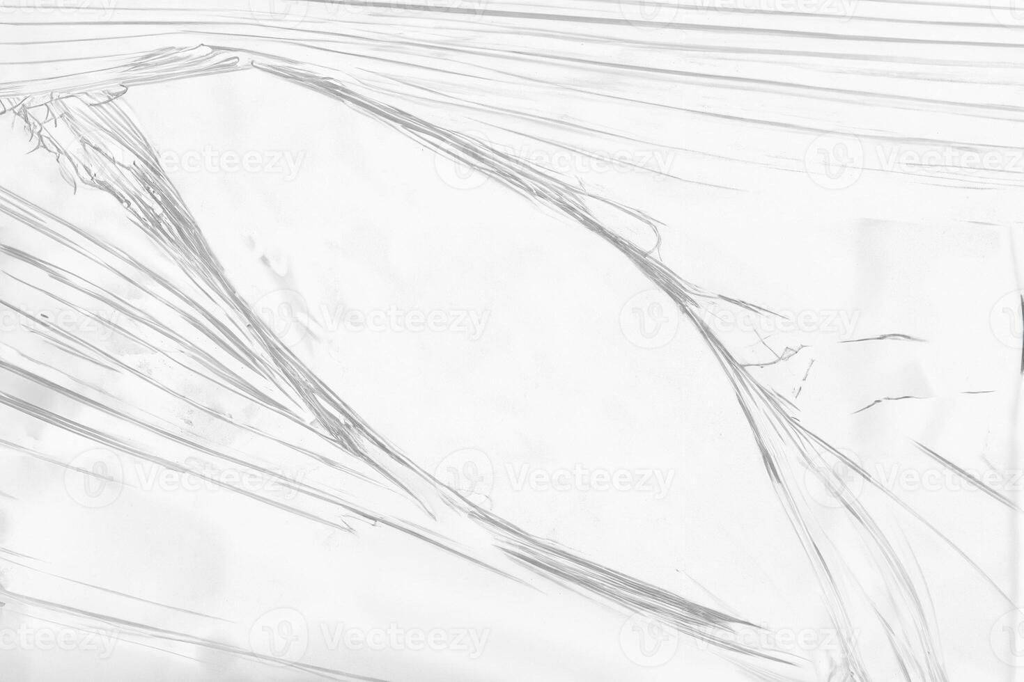 Torn Hole in Clear Plastic Wrap Close-Up photo