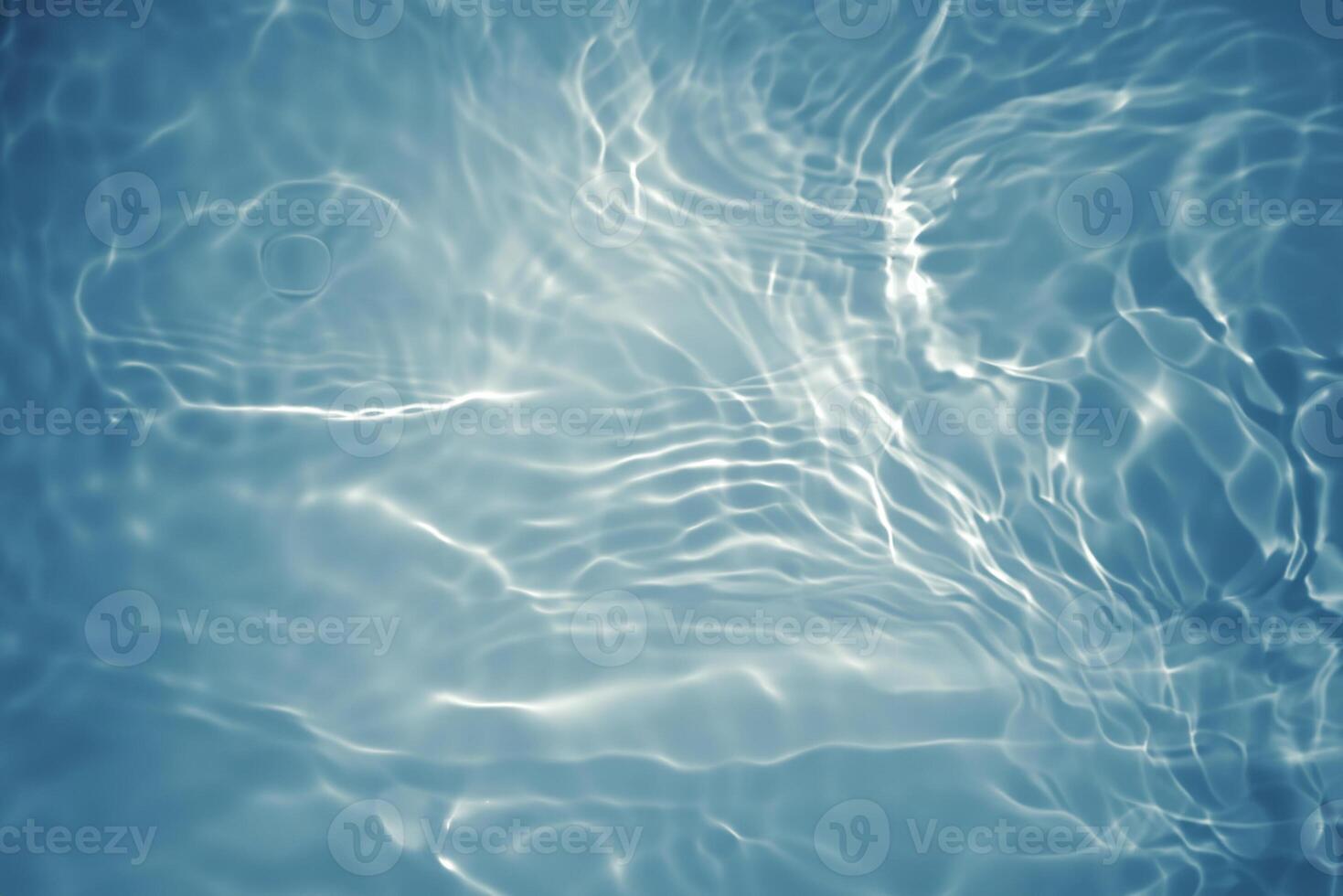 Blurred Blue Water Surface with Ripples and Bubbles photo