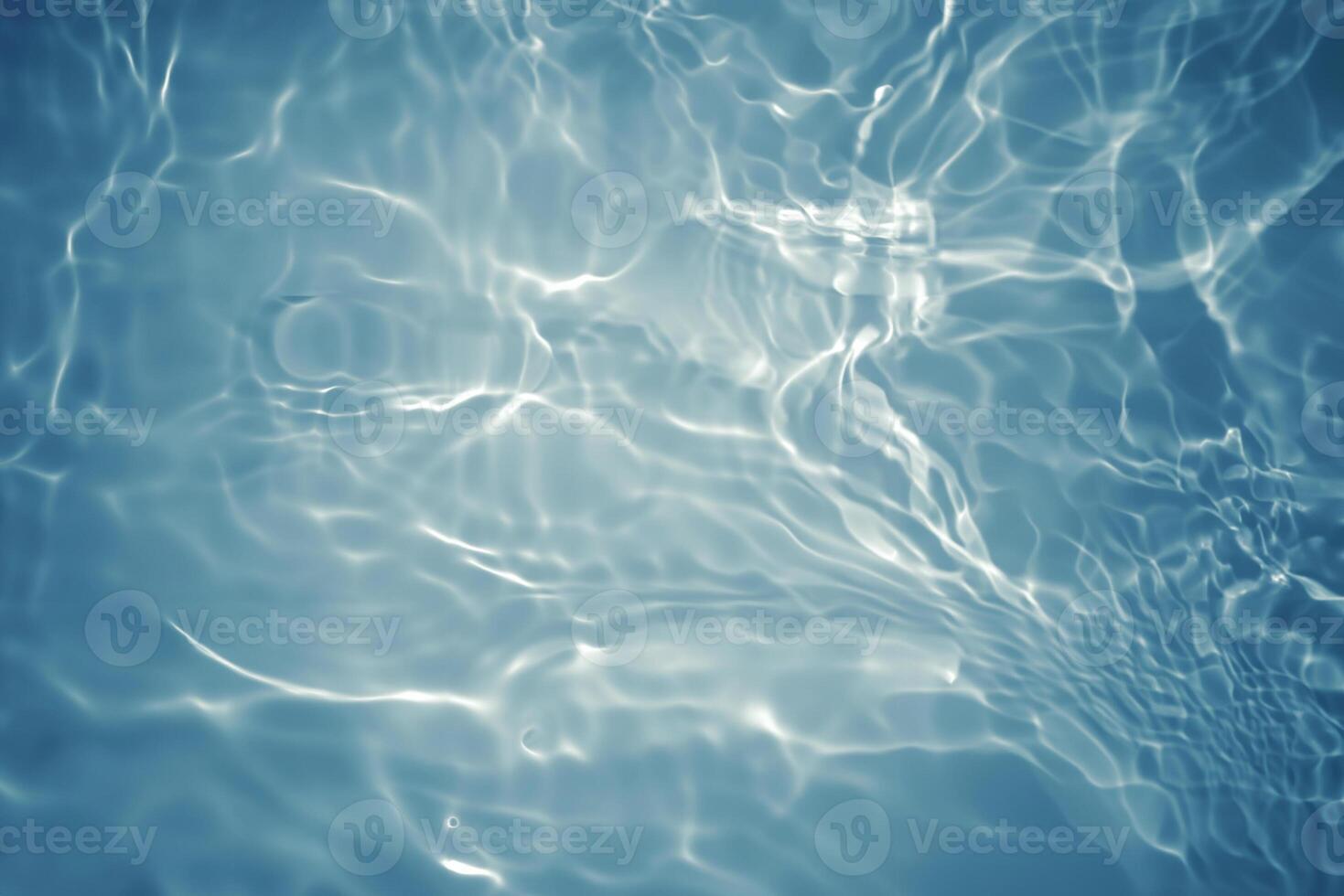 Blurred Blue Water Surface with Ripples and Bubbles photo