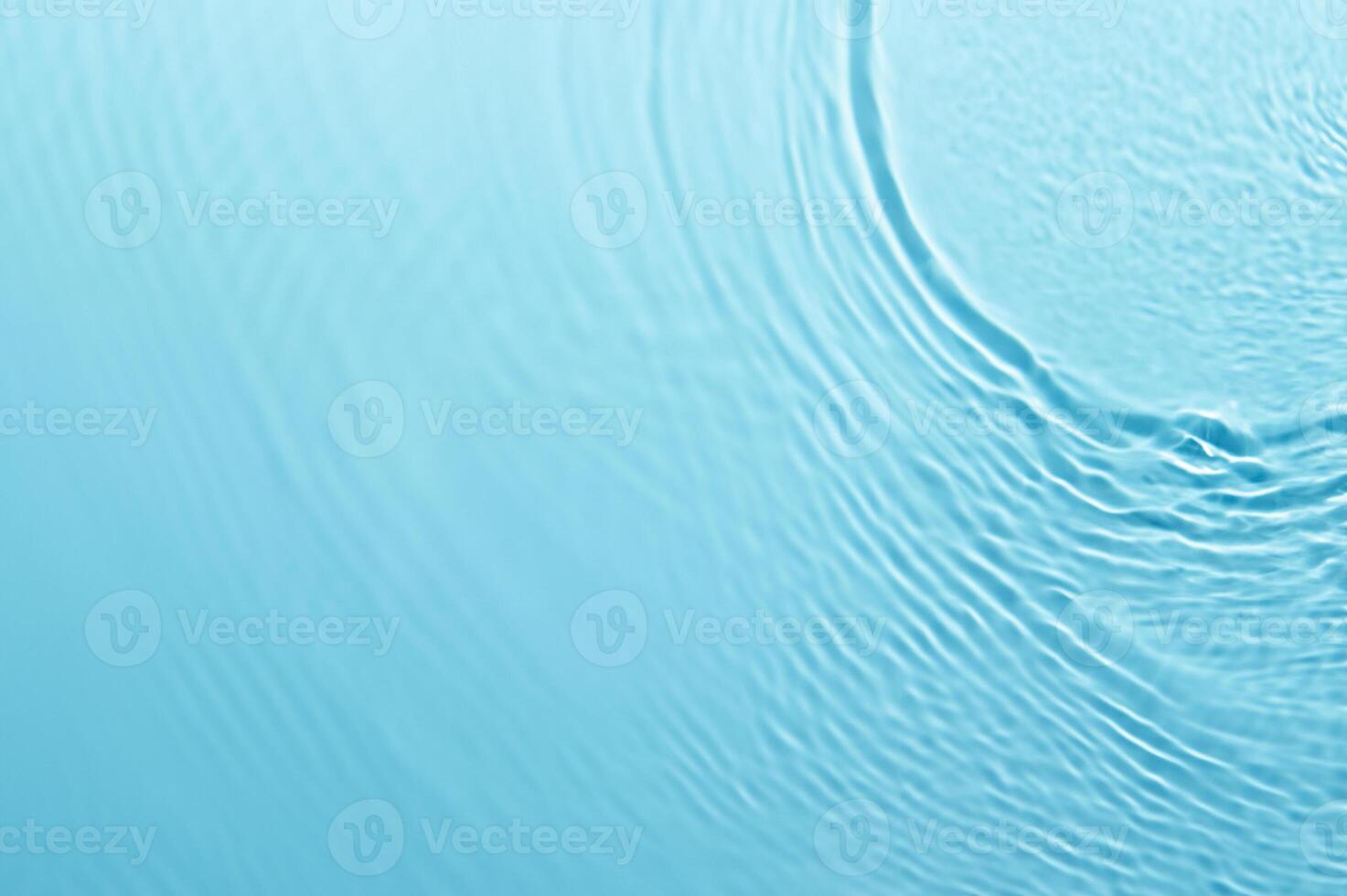 Blurred Blue Water Ripple with Bubbles and Sunlight Reflection - Calm and Clear Background photo
