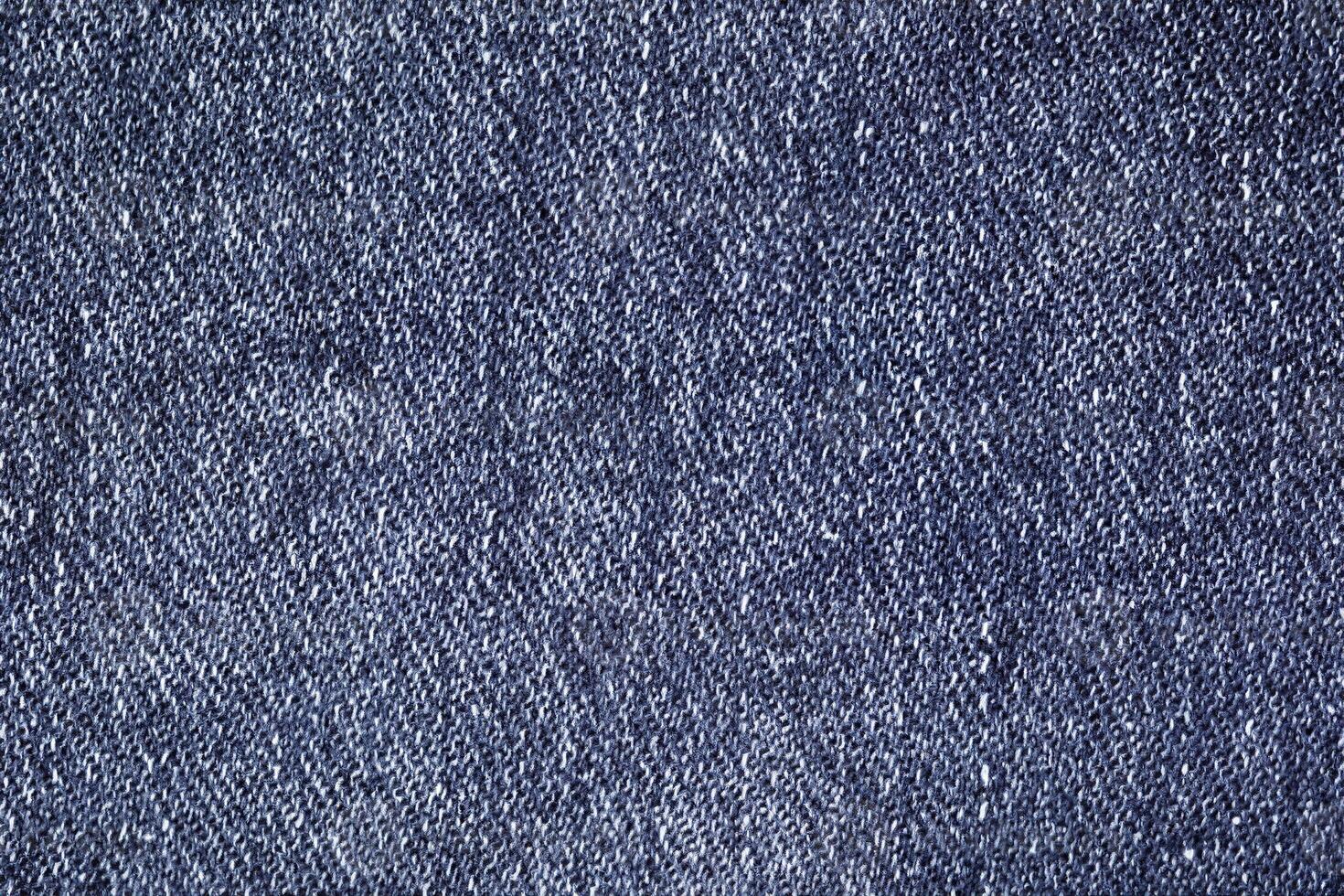 Close-Up of Dark Blue Denim with Visible Stitches and Uniform Texture photo