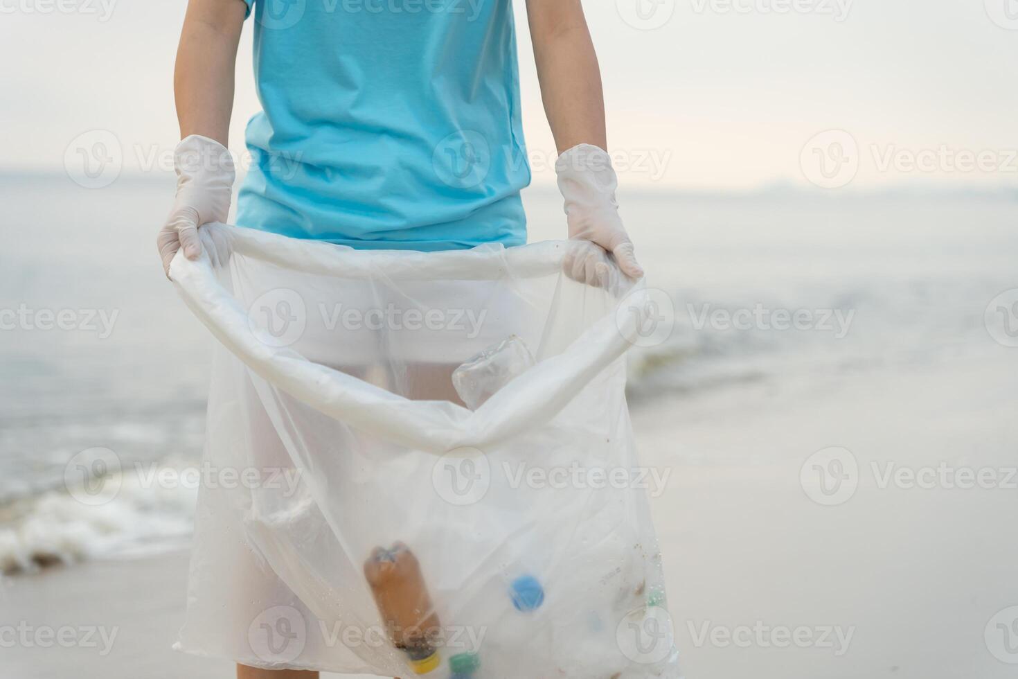 Save water. Volunteer pick up trash garbage at the beach and plastic bottles are difficult decompose prevent harm aquatic life. Earth, Environment, Greening planet, reduce global warming, Save world photo