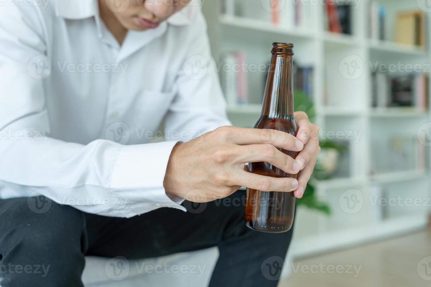 Depressed young business man addicted feeling bad drinking whiskey alone at home, stressed frustrated lonely drinking alcohol suffers from problematic liquor, alcoholism, life and family proble photo