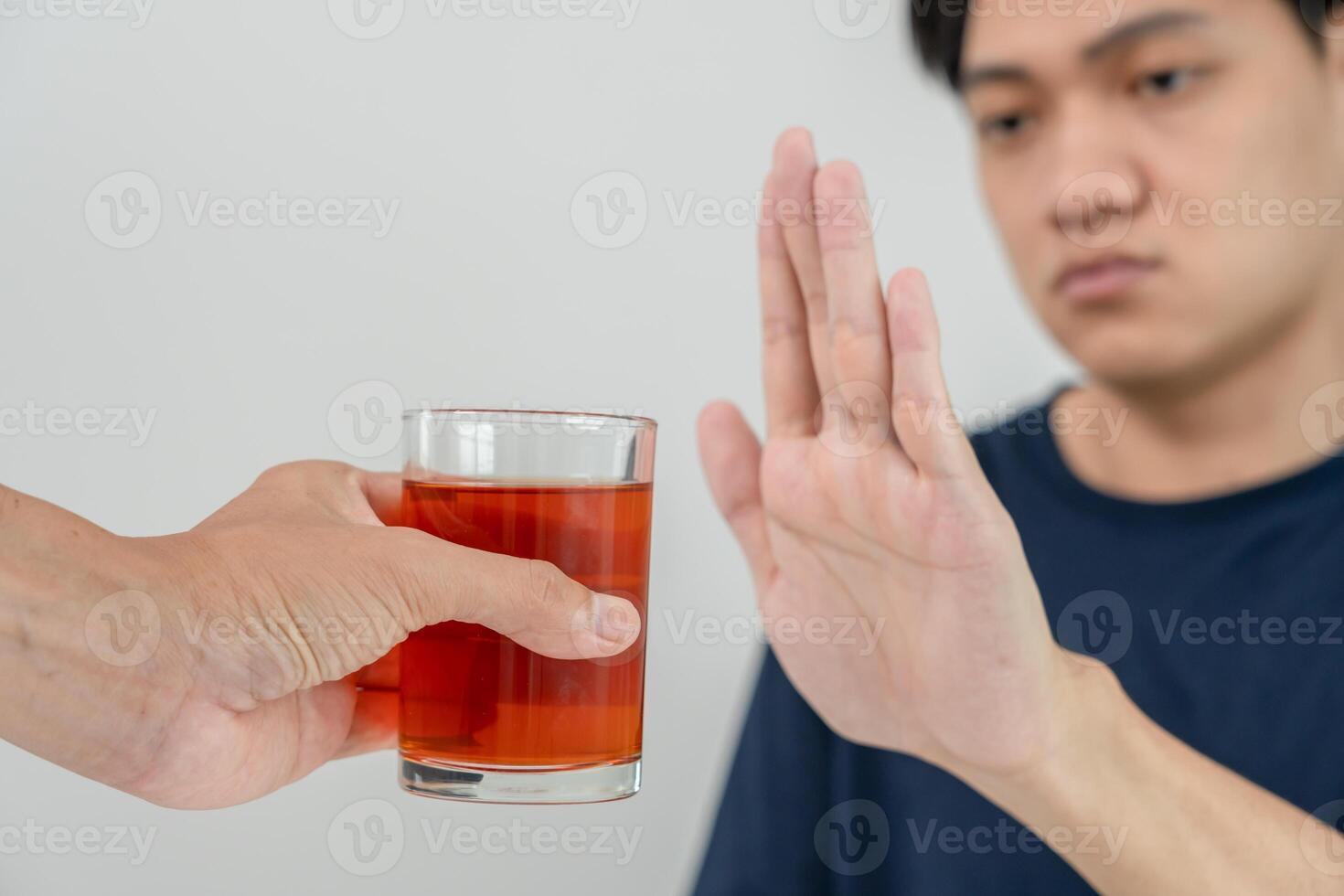 man refuses say no and avoid to drink an alcohol whiskey , stopping hand sign male, alcoholism treatment, alcohol addiction, quit booze, Stop Drinking Alcohol. Refuse Glass liquor, unhealthy, reject photo