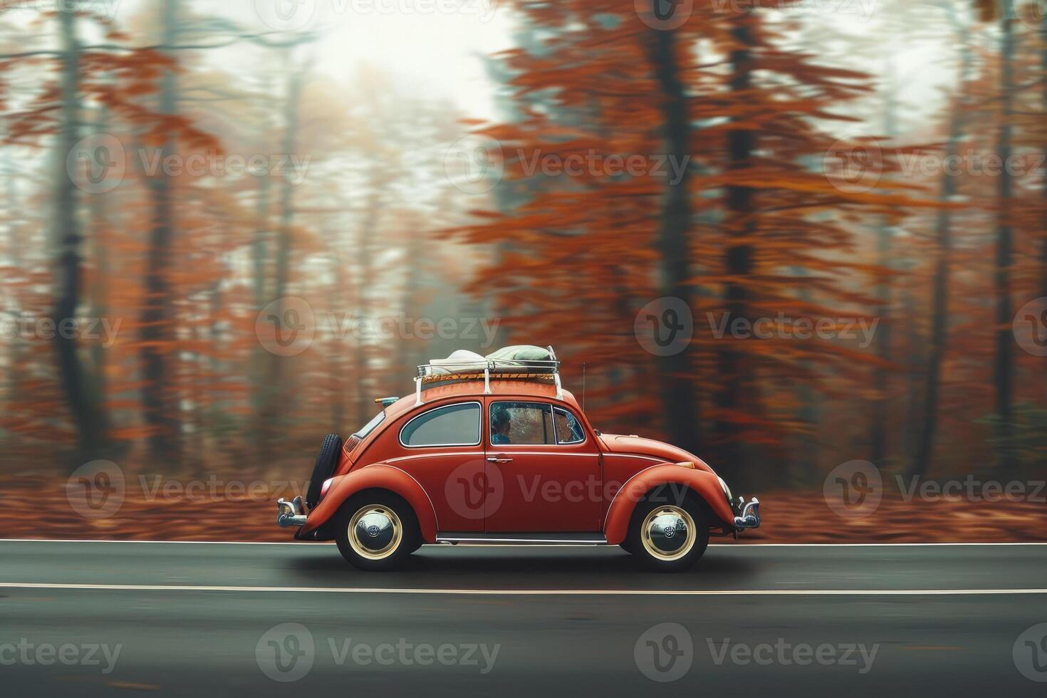 A classic red car driving through a misty autumn forest with vibrant orange leaves, evoking a nostalgic and serene travel vibe. The car has luggage on the roof, indicating a road trip or journey. photo