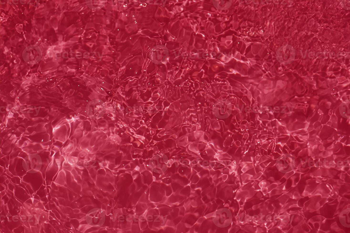 Close-Up of Calm Red Water Surface with Ripples and Reflections photo
