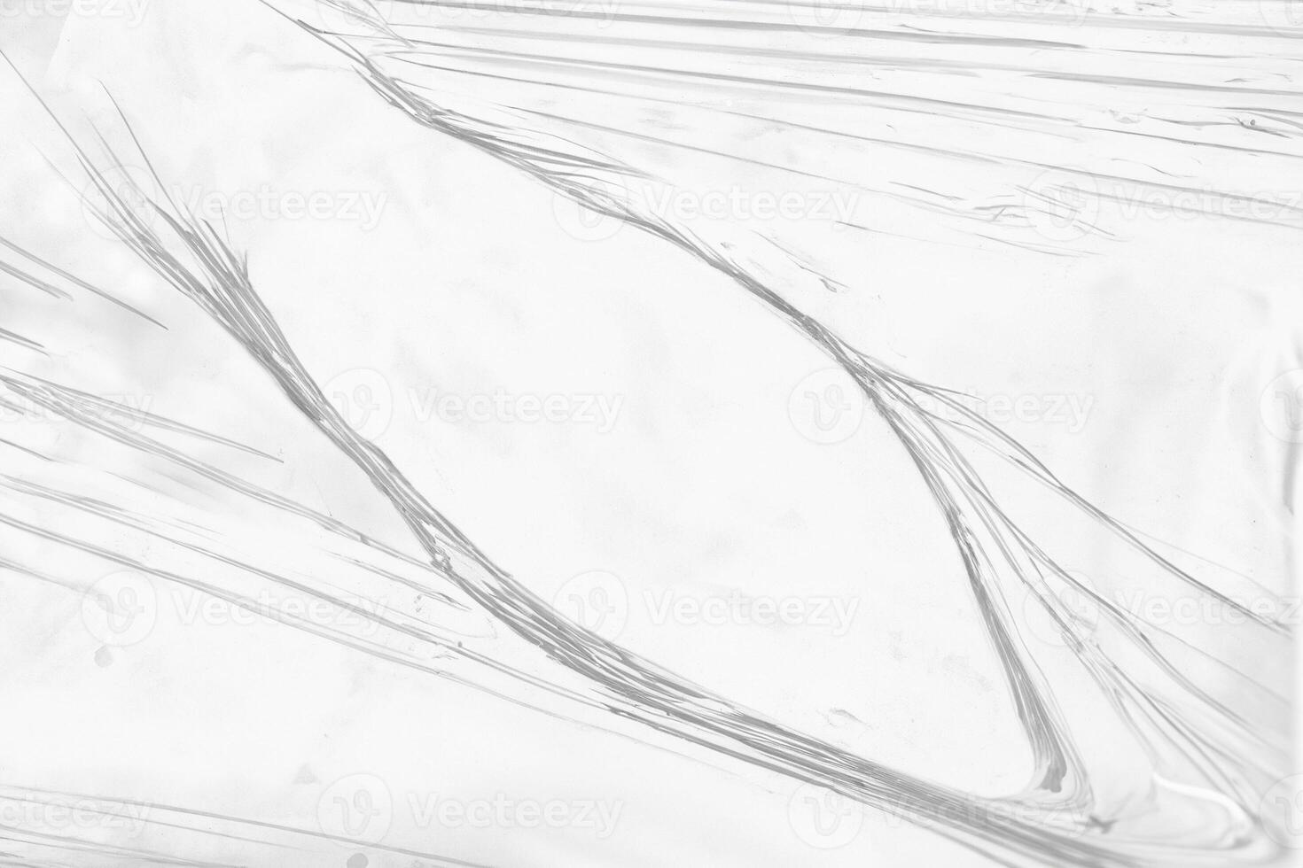 Torn Hole in Clear Plastic Wrap Close-Up photo