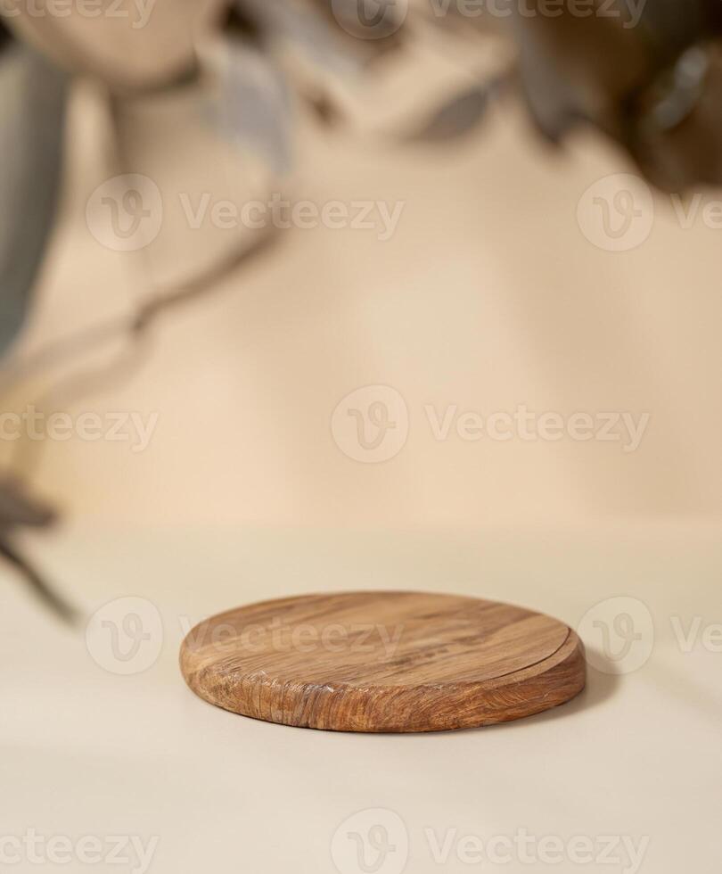 Wooden Round Board with Shadows and Leaves on Beige Background - Product Presentation or Display Concept photo