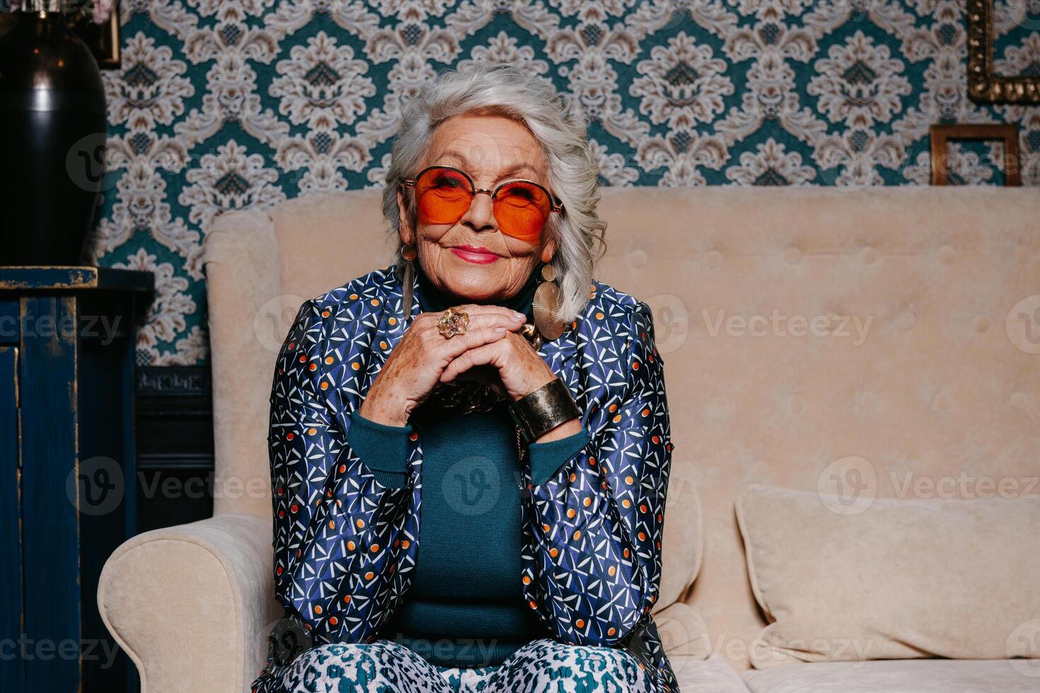 Elegant senior woman in luxury wear radiating confidence and wealth while relaxing at retro style home photo