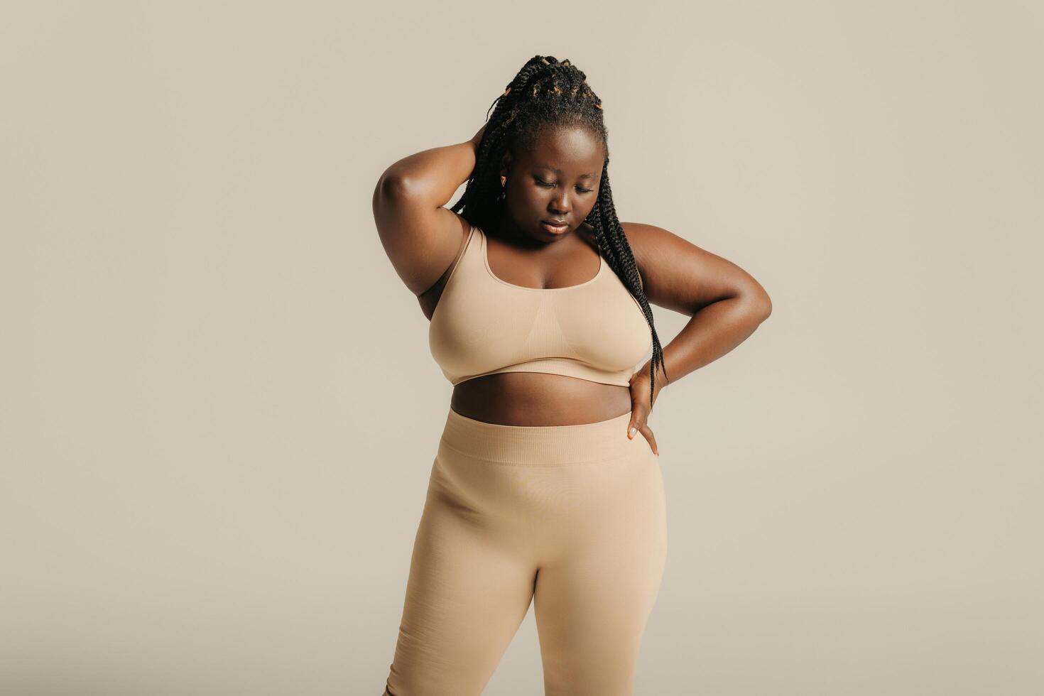 Beautiful curvy African woman in underwear looking confident in her body on studio background photo