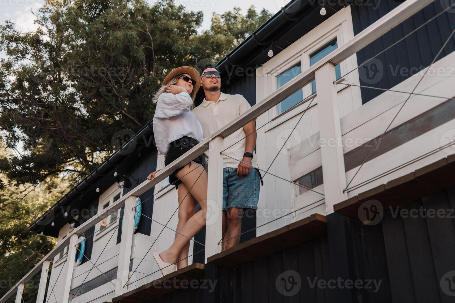 Young romantic couple bonding while spending time on the house terrace together photo
