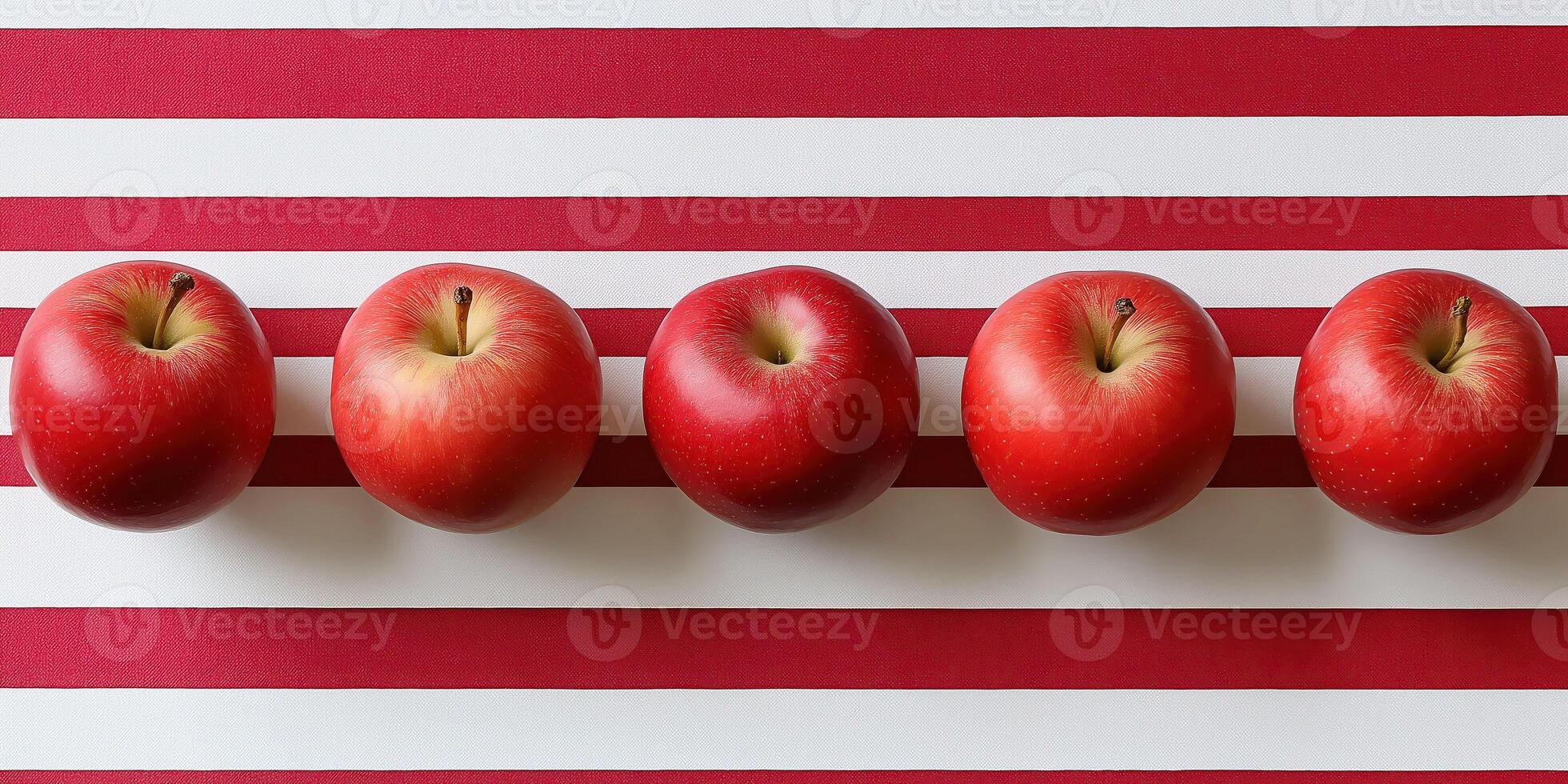 Vibrant red apples on bold striped background for modern aesthetic photo