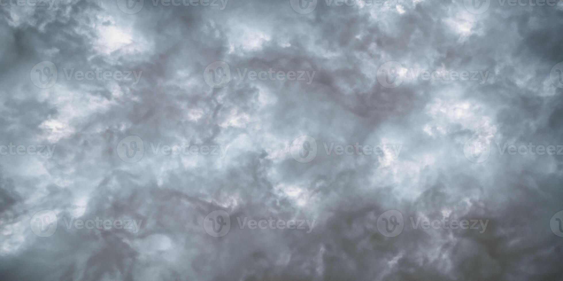 Dramatic cloudscape moody gray storm clouds in a turbulent sky photo