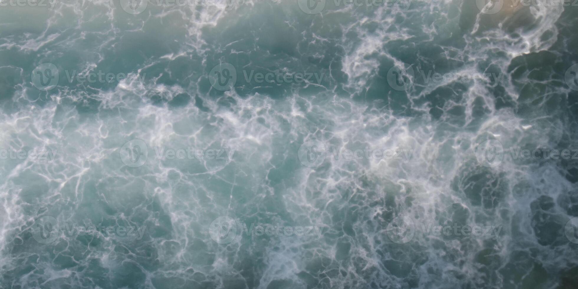 Aerial view of ocean waves crashing mesmerizing turquoise sea patterns photo