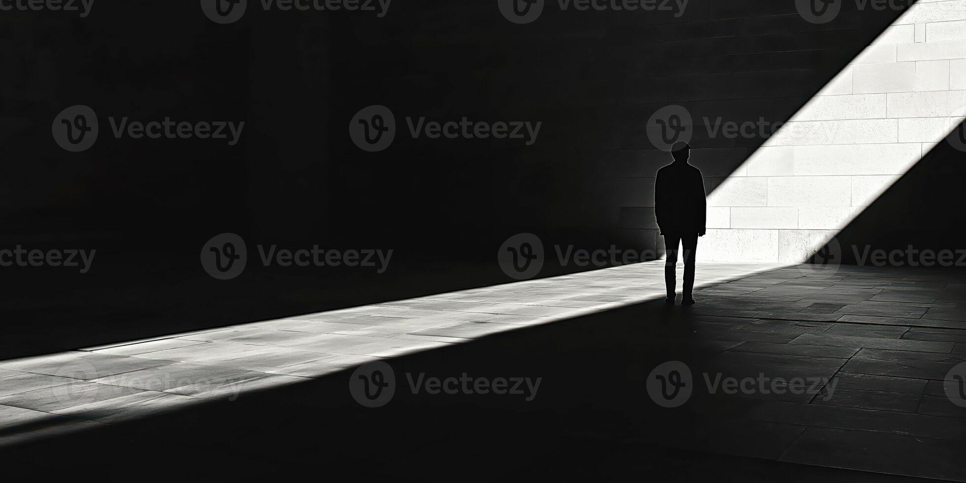 Silhouette of a person in dramatic light beam highlighting urban architecture photo