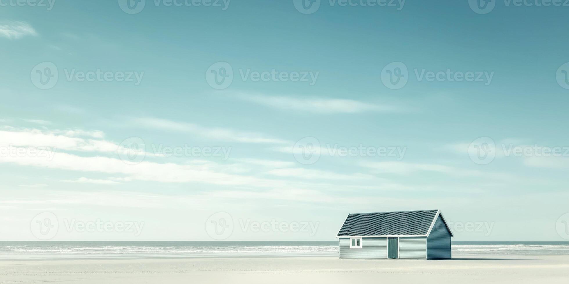 Solitary beach shack on a serene seashore under a vast blue sky photo