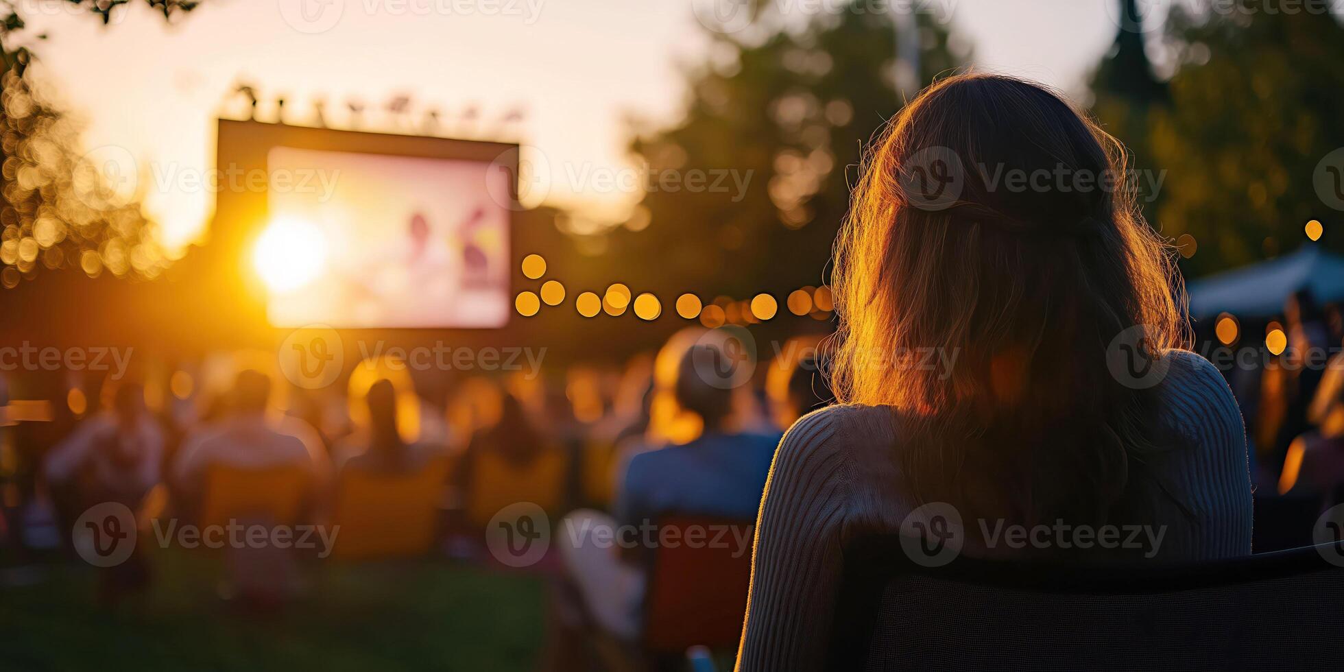 Outdoor movie night people enjoying film under the evening sky photo