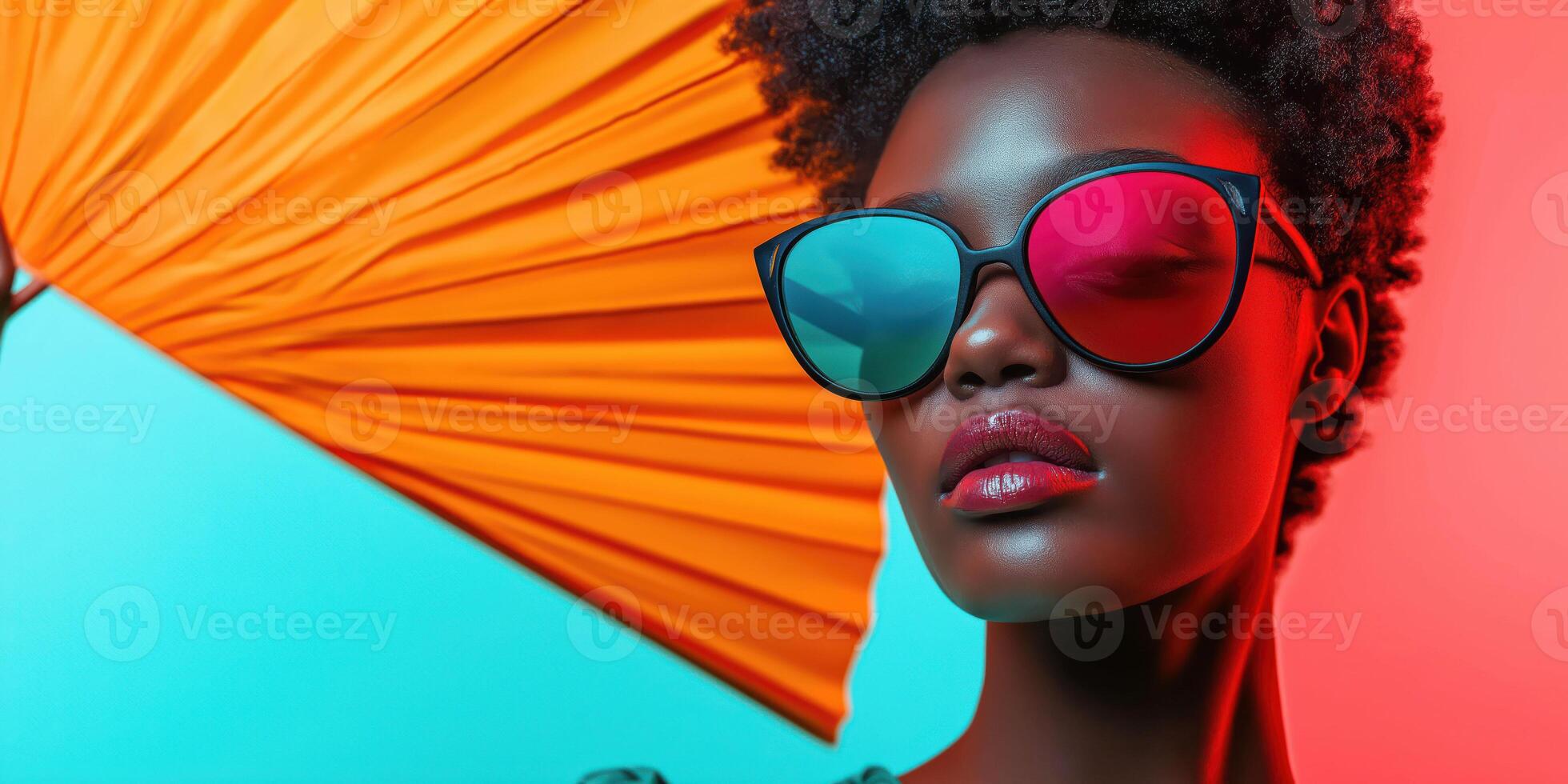 Vibrant portrait of a stylish woman with sunglasses and orange umbrella photo