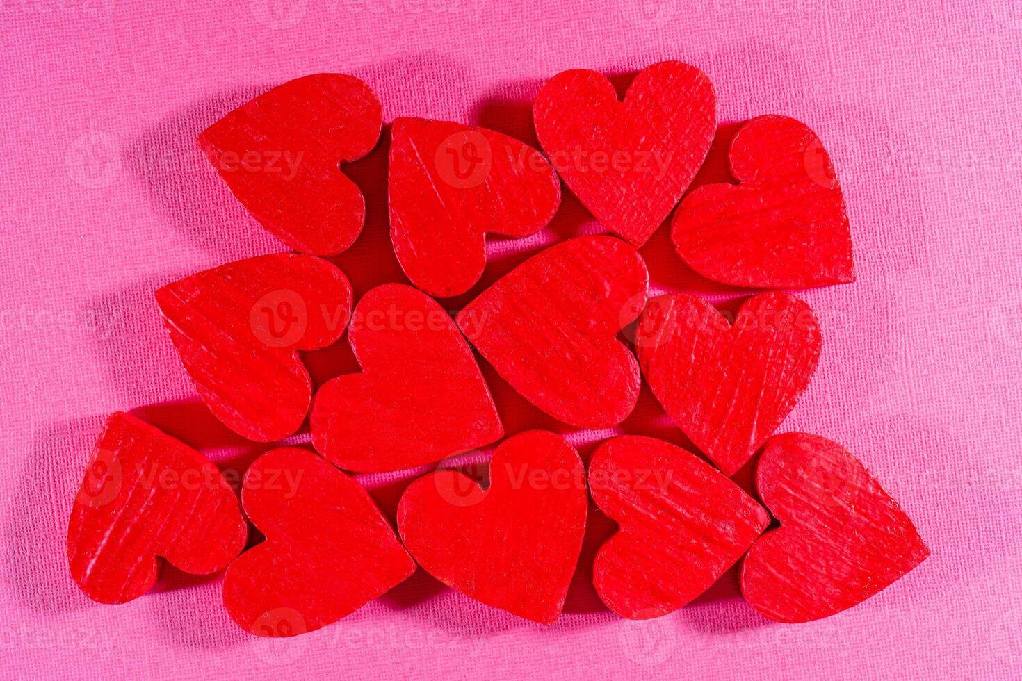 Red hearts on an abstract pink background. Holiday valentine's day greeting card. photo
